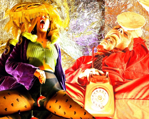 A woman in bold, colourful clothing poses dramatically with her mouth open, while a man in red clothing reclines next to an old-fashioned red telephone; the background is shiny and metallic, creating a surreal scene.