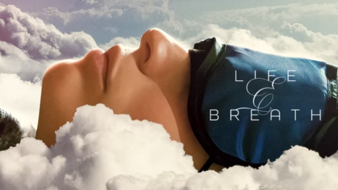 A person lies among fluffy clouds with their eyes covered by a sleep mask. The words Life & Breath appear on the right side of the image, blending into the soft, dreamy atmosphere.