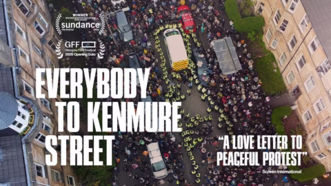 Aerial view of a large crowd and police on a city street between buildings, with text: “Everybody to Kenmure Street” and “A love letter to peaceful protest.” Includes film festival laurels and credits.