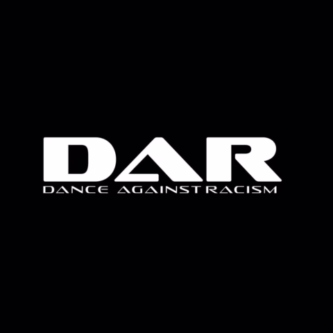 White text on a black background reads DAR in large letters, with DANCE AGAINST RACISM in smaller font below. The A in DAR is stylised as a triangle.